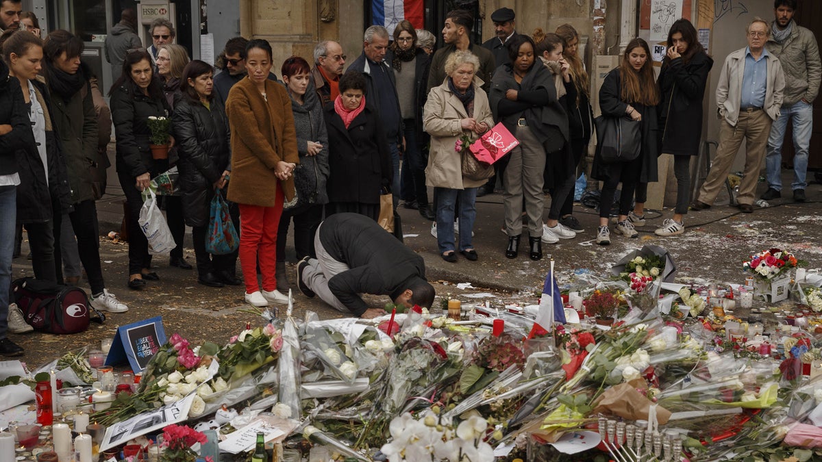  A Muslim, center, prays in front of a floral tributes near the Bataclan concert hall after the terrorist attacks in Paris, Monday, Nov. 16, 2015.  France is urging its European partners to move swiftly to boost intelligence sharing, fight arms trafficking and terror financing, and strengthen border security in the wake of the Paris attacks. (AP Photo/Daniel Ochoa de Olza) 