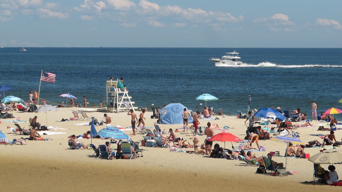 Beach-goers enjoy picture-perfect weather Thursday in Long Branch, New Jersey, where U.S. Rep. Frank Pallone and U.S. Sen. Bob Menendez urged federal lawmakers to reauthorize the Beach Act. (Phil Gregory/for WHYY)) 