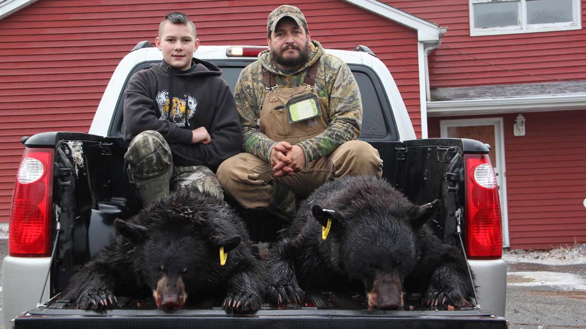 Bummer Cronk of Oak Ridge and his son, Hunter, 12, pose with their opening-day bears. (Emma Lee/for NewsWorks)