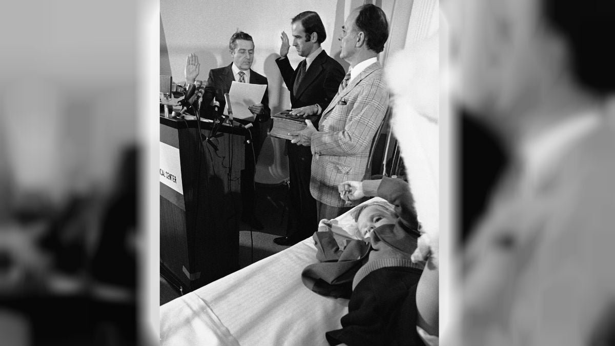  In this 1973 photo, four-year-old Beau Biden lies in a hospital bed as his dad is sworn in as the U.S. senator from Delaware. Beau was injured in an accident that killed his mother and sister in December 1972. (AP Photo/File) 