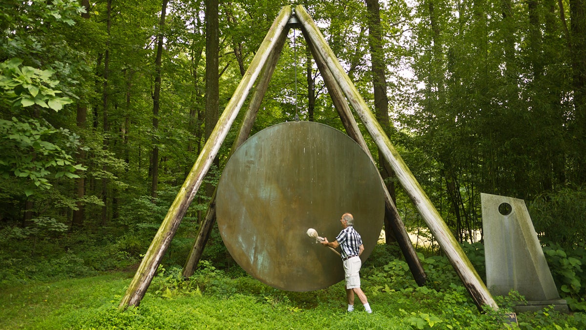  Harry Bertoia's son, Val, demonstrates one of his father's gong sound sculptures outside of his studio in Bally, Pa.  (Charlie Kaier/WHYY) 