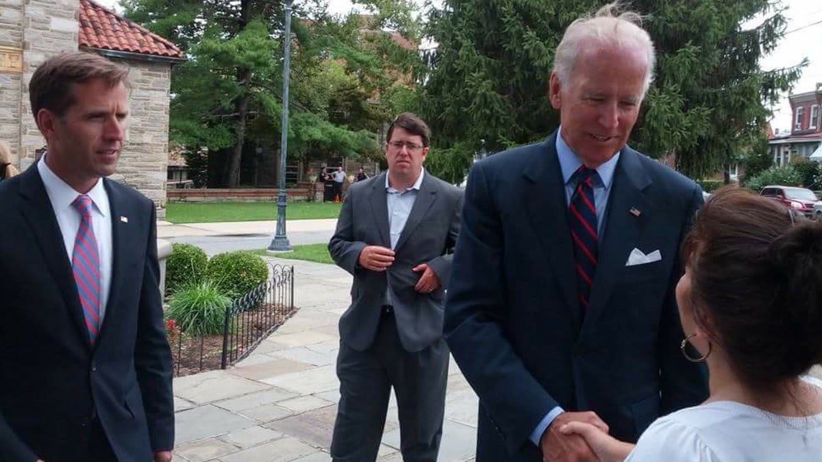  Vice President Joe Biden and Attorney General Beau Biden are shown paying their respects to Wilmington, Delaware, priest Father Roberto in August 2013. (Image courtesy of Nichole Dobo) 