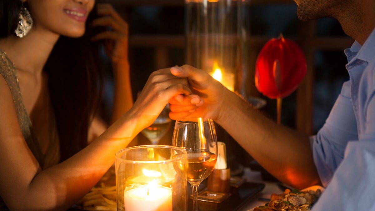 (<a href='https://www.bigstockphoto.com/image-113651627/stock-photo-romantic-couple-holding-hands-together-over-candlelight-during-romantic-dinner'>luckybusiness</a>/Big Stock Photo)