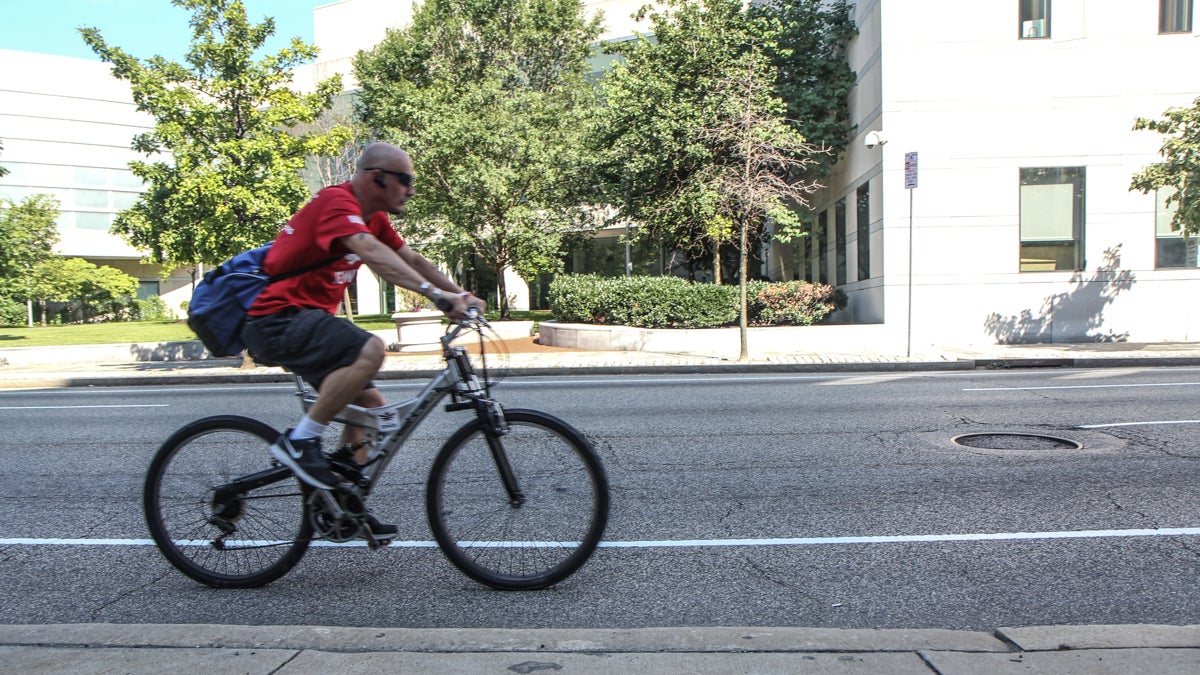  A cyclist rolls by the Constitution Center Friday afternoon. (Kimberly Paynter/WHYY) 