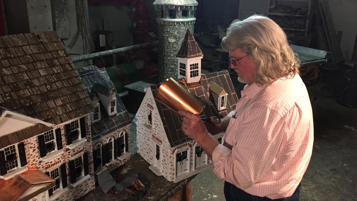 Artist and craftsman Tom Burke works on a birdhouse in his Wilmington studio. (Brian Drouin/WHYY)