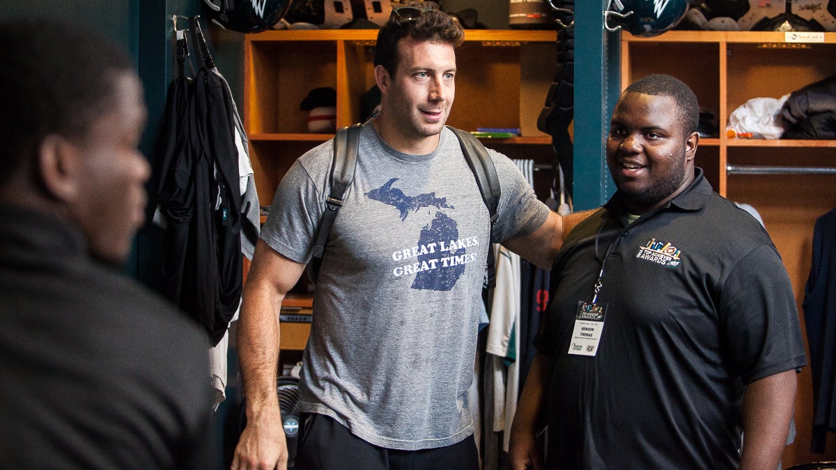  Imhotep Charter's Gordon Thomas meets Eagles linebacker Connor Barwin in the Eagles locker room. (Brad Larrison/for NewsWorks) 