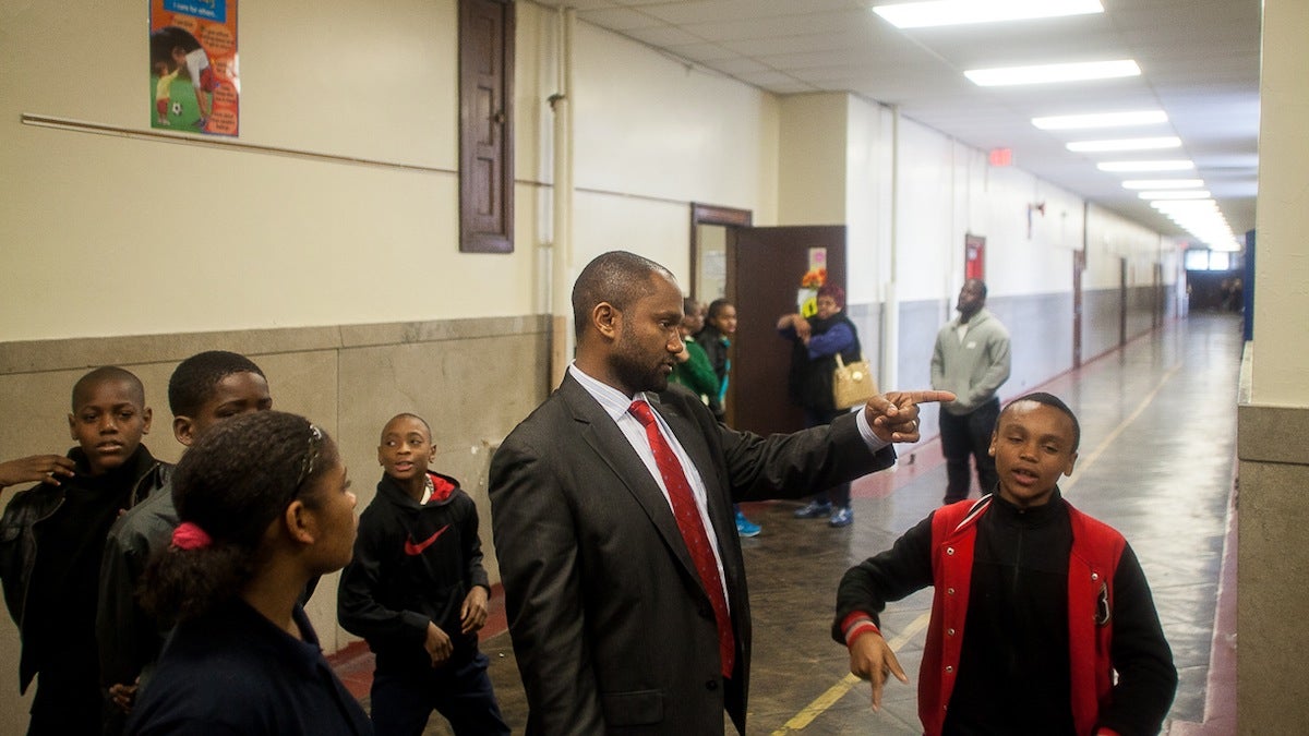 4. Principal Bryon Ryan directs groups of students to various workshops emphasizing good behavior. (Brad Larrison/for NewsWorks)