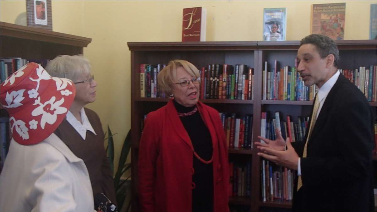  Black Writers Museum Director Supreme Dow speaks with visitors at Saturday's grand re-opening event in Germantown. (Queen Muse/for NewsWorks) 