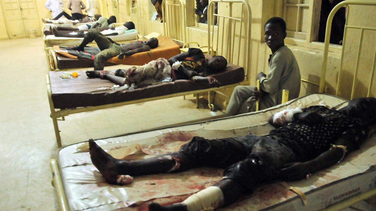  Injured men and boys receive treatment at a local hospital following an explosion at a mobile phone market in Kano, Nigeria. Wednesday Nov. 18, 2015. (AP Photo/Muhammed Giginyu) 