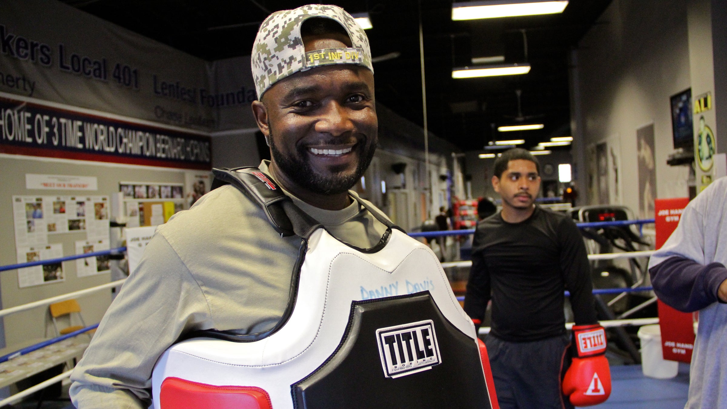  Veteran Wendell Chavis finds his joy at Joe Hand boxing gym, where he helps to train young fighters like Bryan Roque (right). (Emma Lee/WHYY) 