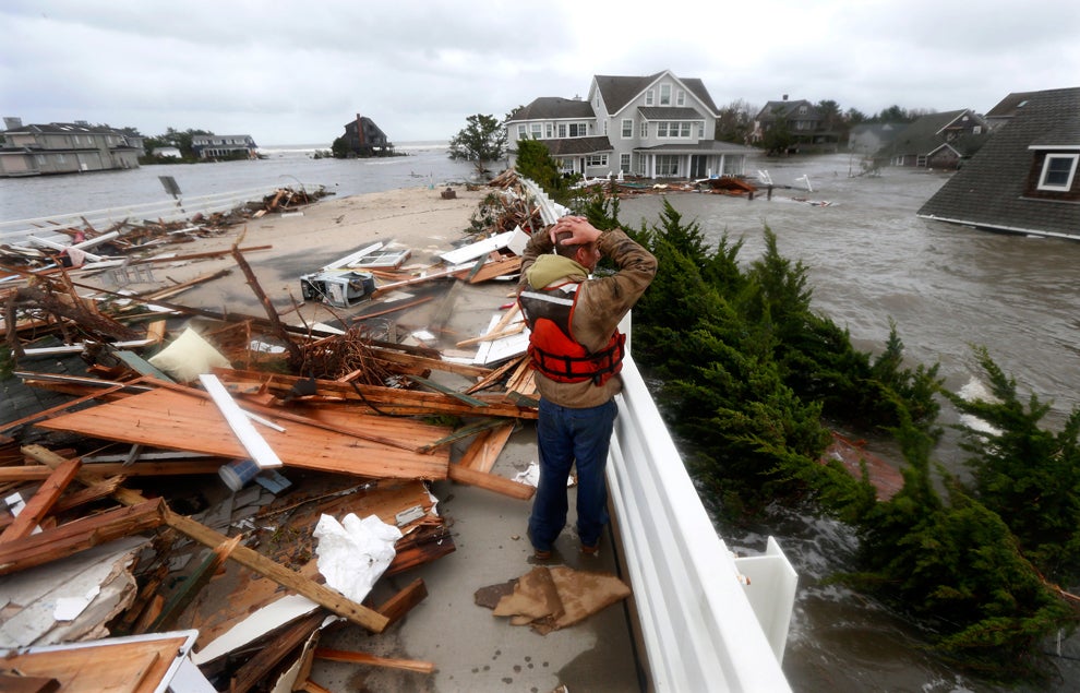  Brian Hajeski of Brick, N.J., stares at the stunning devastation, surrounded by the debris of a home that struck the Mantoloking Bridge in Brick during the deadly storm. Photo: Julio Cortez, Associated Press 