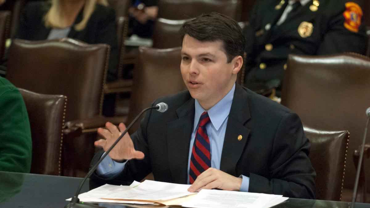 A fresh-faced, Pa. state Rep. Brendan F. Boyle seated at a table, speaking into a mic, papers in front of him