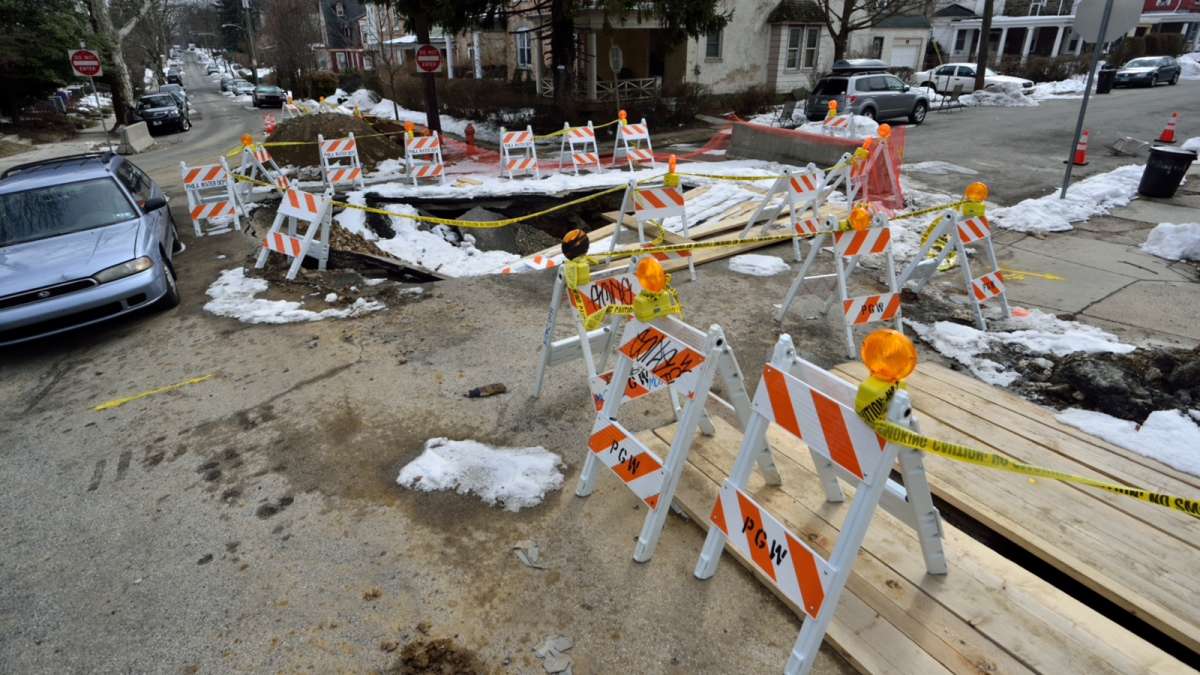  The crater first appeared after an eight-inch water main burst beneath the concrete and damaged a sewer line. (Bas Slabbers/for NewsWorks) 