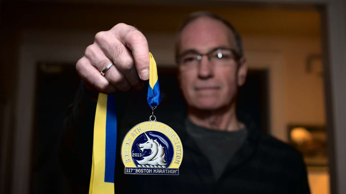  Randy Clever holds his medal from the 2013 Boston Marathon. He will return for the April 21 race. (Bas Slabbers/for NewsWorks) 