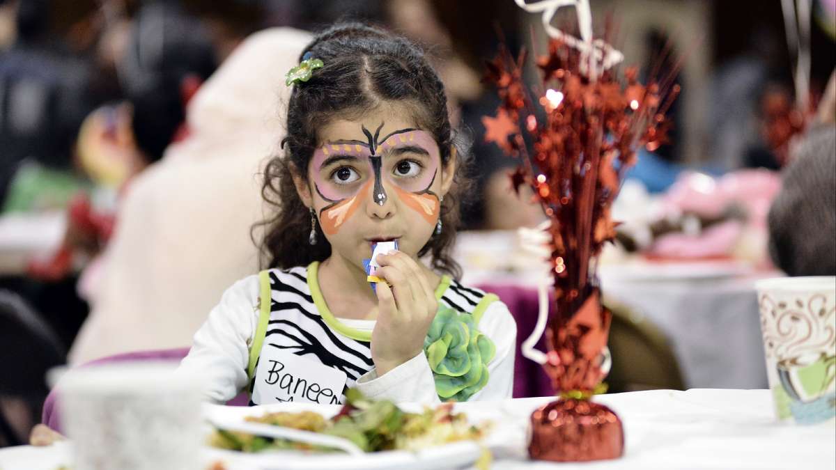 Refugees from all over the world enjoy their first Thanksgiving dinner at the Old Pine Community Center on Sunday. (Bastiaan Slabbers for NewsWorks)