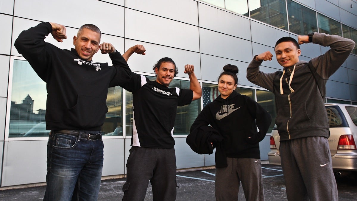  Steve's Club owner Steve Liberati with Camden CrossFit participants CJ Chaparro, Gabby Dominguez and Dominic Dominguez. (Kimberly Paynter/WHYY) 