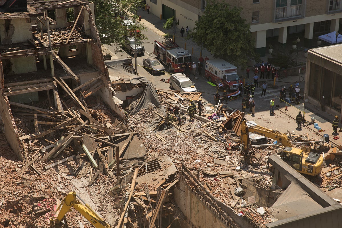 Firefighters search through rubble and debris after a building collapsed on Market and 22ns Streets,  Wednesday, June 5, 2013 (Lindsay Lazarski/WHYY)