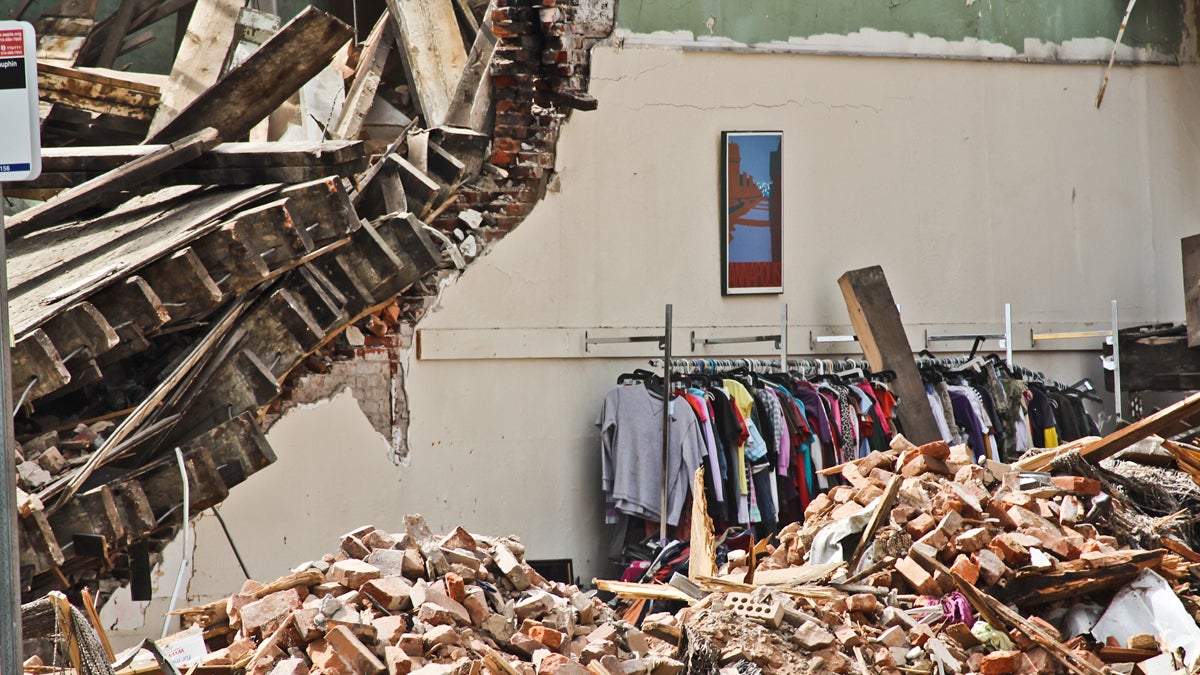  A painting and clothing rack remain in the Salvation Army Thrift Store the day after an adjacent building collapsed onto the shop. (Kimberly Paynter/WHYY) 