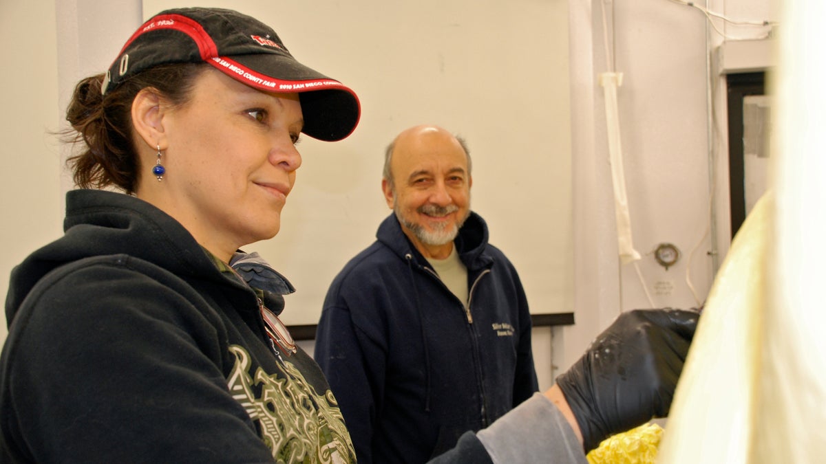 Marie Pelton works on the butter sculpture while Jim Victor looks on. (Photo provided by the Mid-Atlantic Dairy Association)