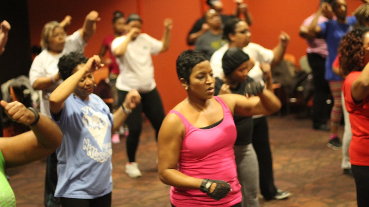 Fitness instructor Nicki Jones leads an exercise class at Lucile H. Bluford Library in Kansas City. (Calvin Jones/for WHYY)