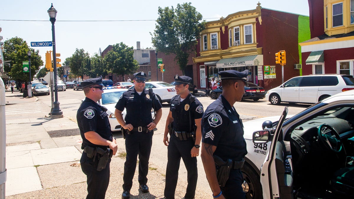 Officers stand on Haddon Avenue in Camden, New Jersey. (Brad Larrison/for NewsWorks) 