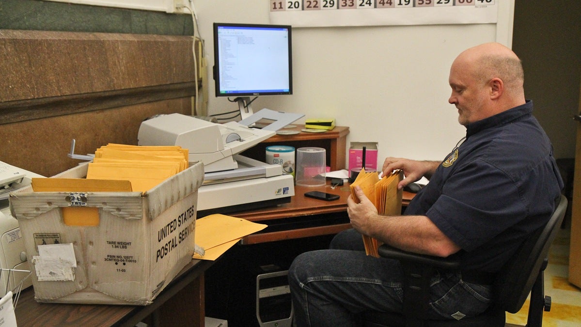  Timothy Dowling, acting supervisor of elections, sorts through candidates' campaign filings Monday. (Kimberly Paynter/WHYY) 
