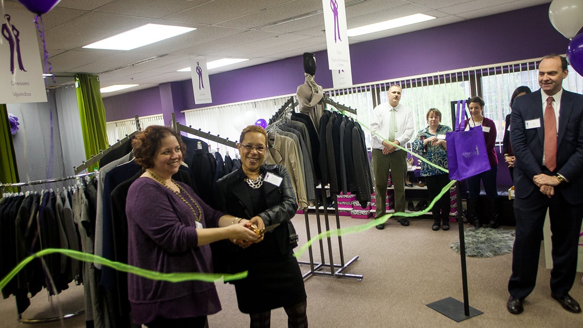 Executive Director of Career Wardrobe Sheri Cole, left, and founder Rondabay Liggins-McCoy cut the ribbon to officiall open the new location in Chester, Pa. (Brad Larrison for NewsWorks)