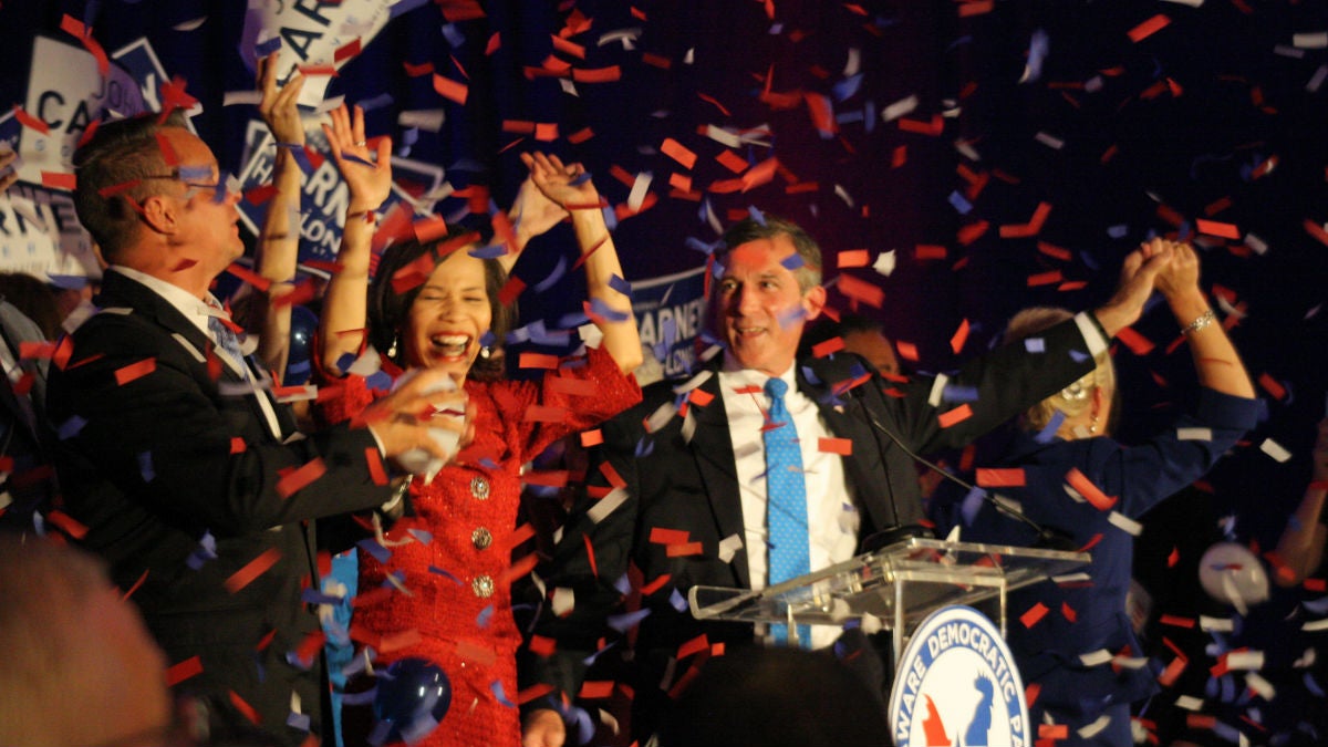 Governor-elect John Carney (blue tie) celebrates with the woman who will replace him in Congress