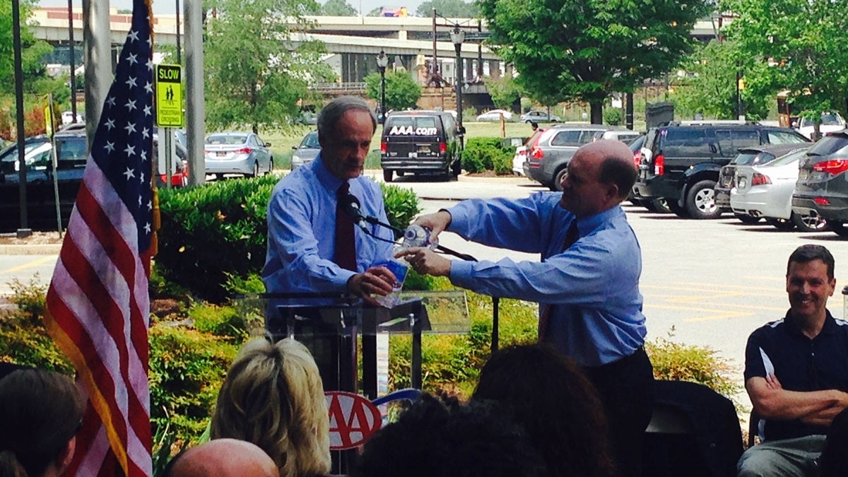  Delaware's Senators Carper and Coons use water bottles to demonstrate the challenge facing transportation funding in Congress. (Mark Eichmann/WHYY) 