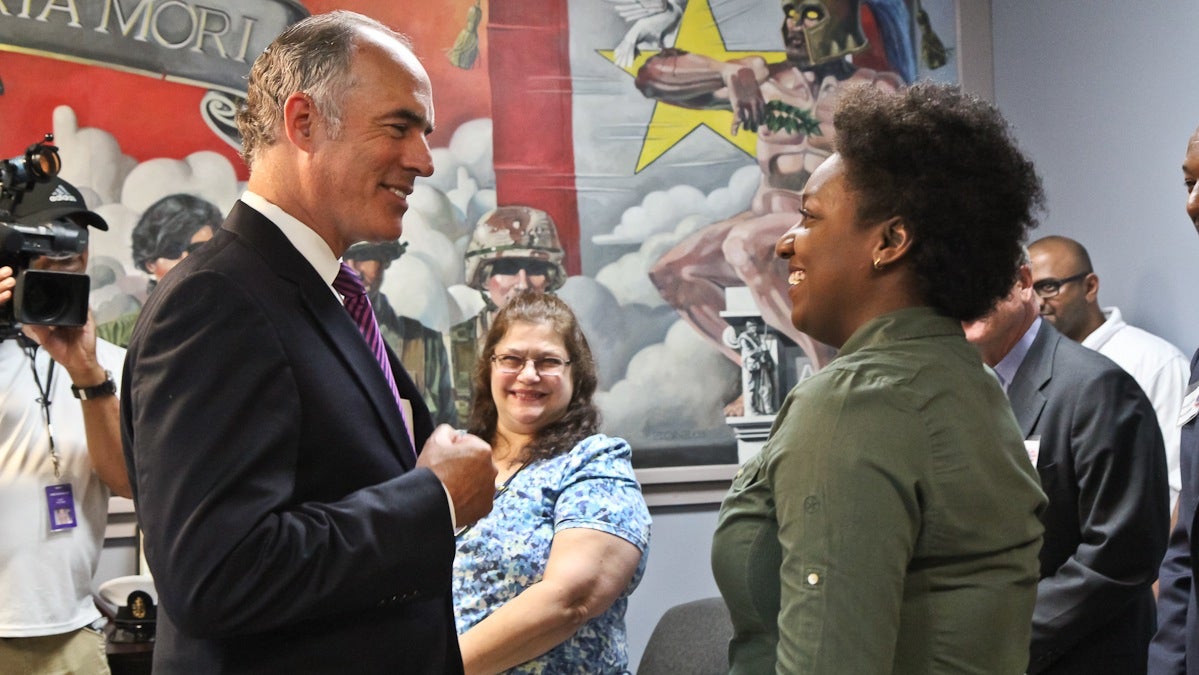 U.S. Sen. Bob Casey introduces himself to Cassondra Flanagan, an Army veteran, at the Veterans Multi-Service Center in Philadelphia. (Kimberly Paynter/WHYY) 