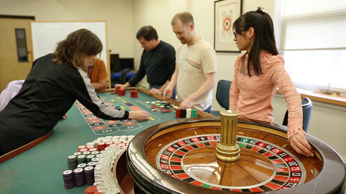  Students gather around the roulette table during the casino training program at Northampton Community College in Bethlehem, Pa. (Lindsay Lazarski/WHYY) 