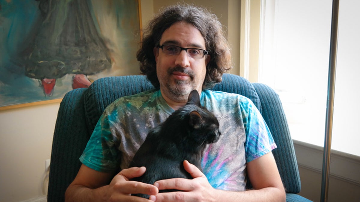 Gerrick Riddenbach and his cat Coal