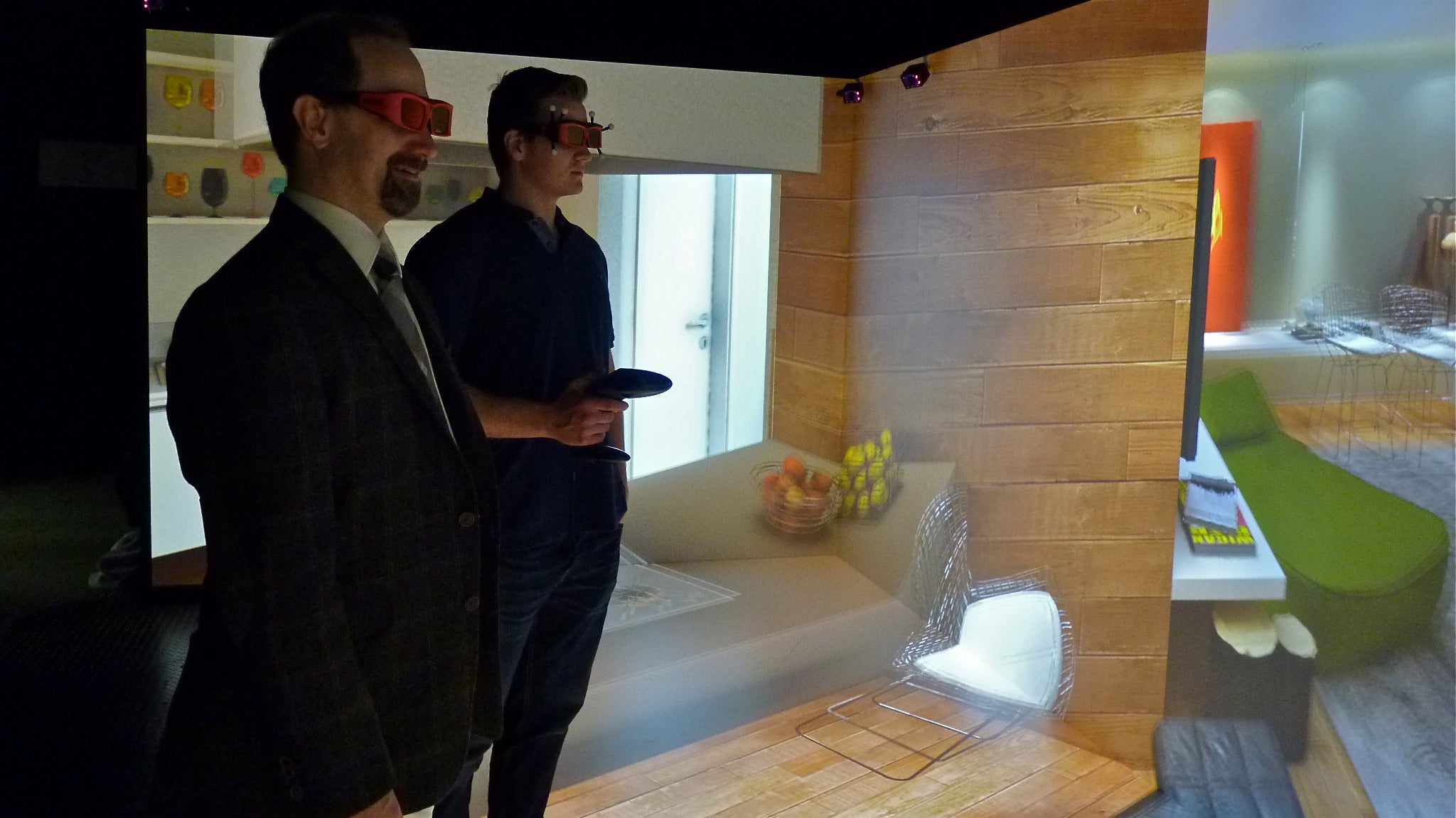 Villanova freshman Charles Walberg (right) explores a virtual room with computer science professor Frank Klassner. They are inside of a 'CAVE immersive learning space
