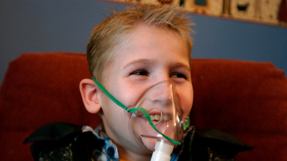 A cystic fibrosis patient receives one of his twice daily treatments for cystic fibrosis (AP Images