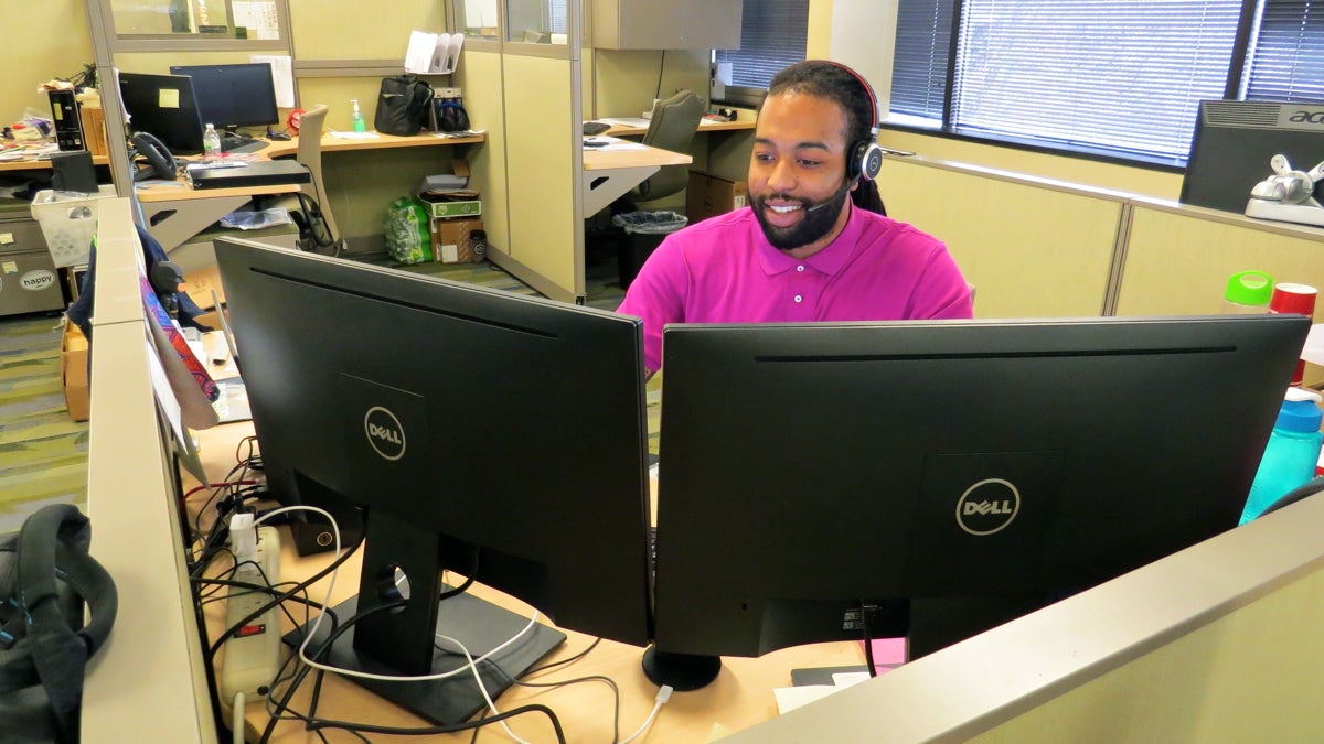 ITWorks graduate Aundre Chambers had to drop out of college because he couldn't afford the tuition. He now works as an IT service desk analyst at WSFS Bank in Wilmington. (Rob Zawatski/WHYY)