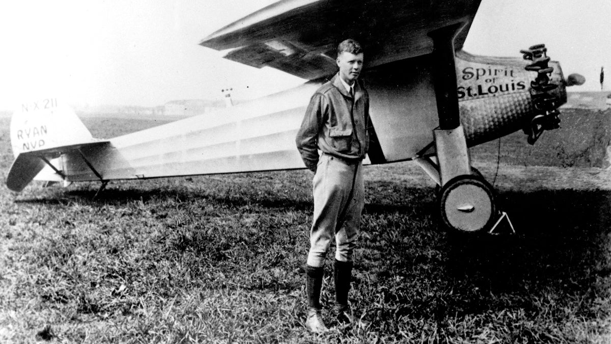  Charles A. Lindbergh is shown in this 1927 file photo with his plane, the Spirit of St. Louis, with which he made the first solo crossing of the Atlantic Ocean from west to east, the same year. (AP Photo, file) 