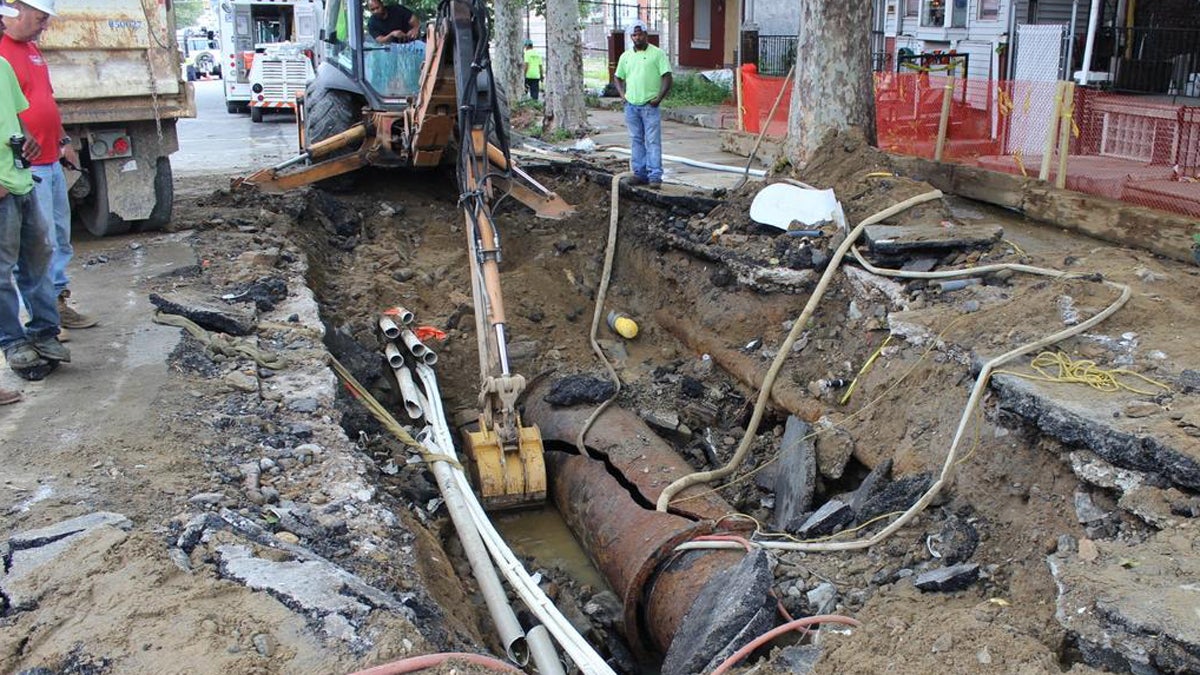  Workers look over the broken main that caused widespread flooding in West Philadelphia.  The Water Department is posting updates on the burst main. (Philadelphia Water Department) 