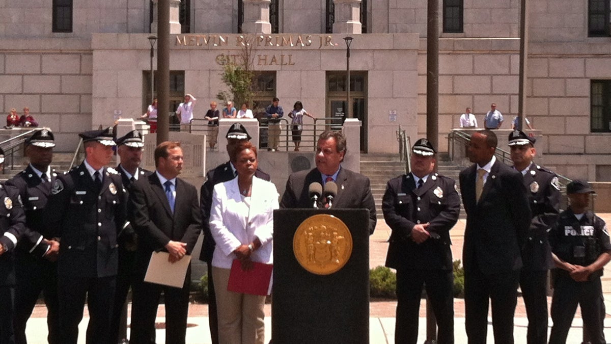  Gov. Chris Christie and Camden Mayor Dana Redd talk about  the year-old Camden County Police force and its impact on crime in the region. (Steve Trader/WHYY) 