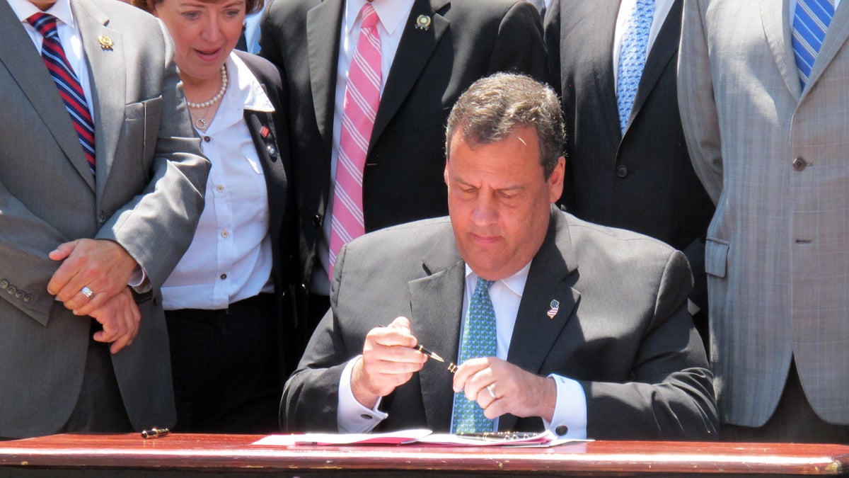  New Jersey Gov. Chris Christie signs a bill into law extending the cap on arbitration awards for police and firefighters. (Phil Gregory/for NewsWorks) 