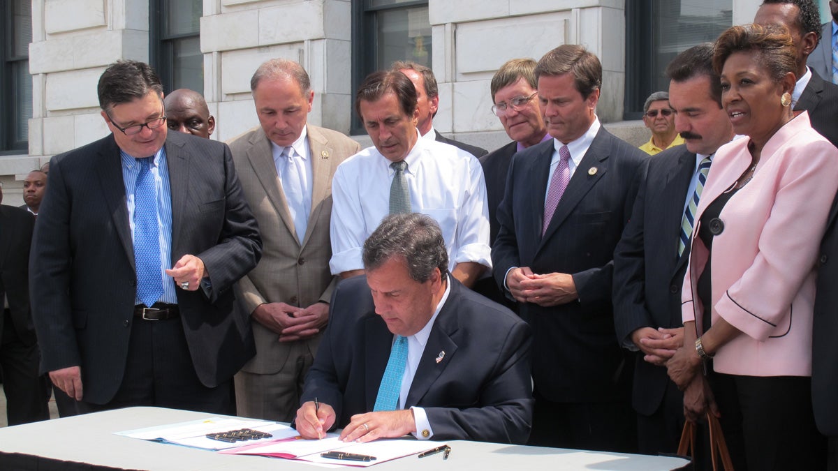  N.J. Gov. Chris Christie signs bail reform legislation in a ceremony on the steps of Trenton's City Hall. (Phil Gregory/for NewsWorks) 