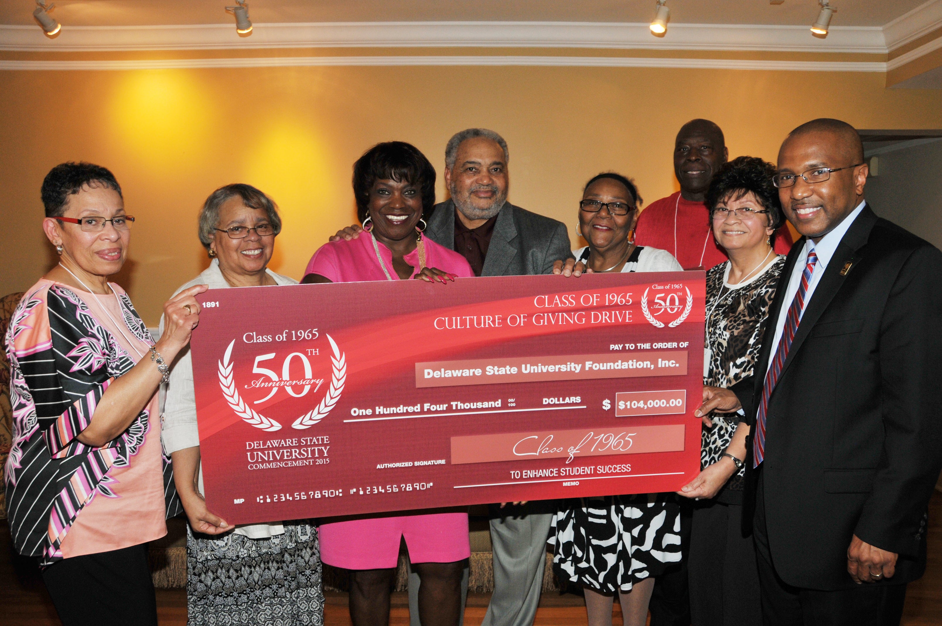  Members of the class of 1965 present their record gift at a May 18 reception. (Photo courtesy of Delaware State University) 