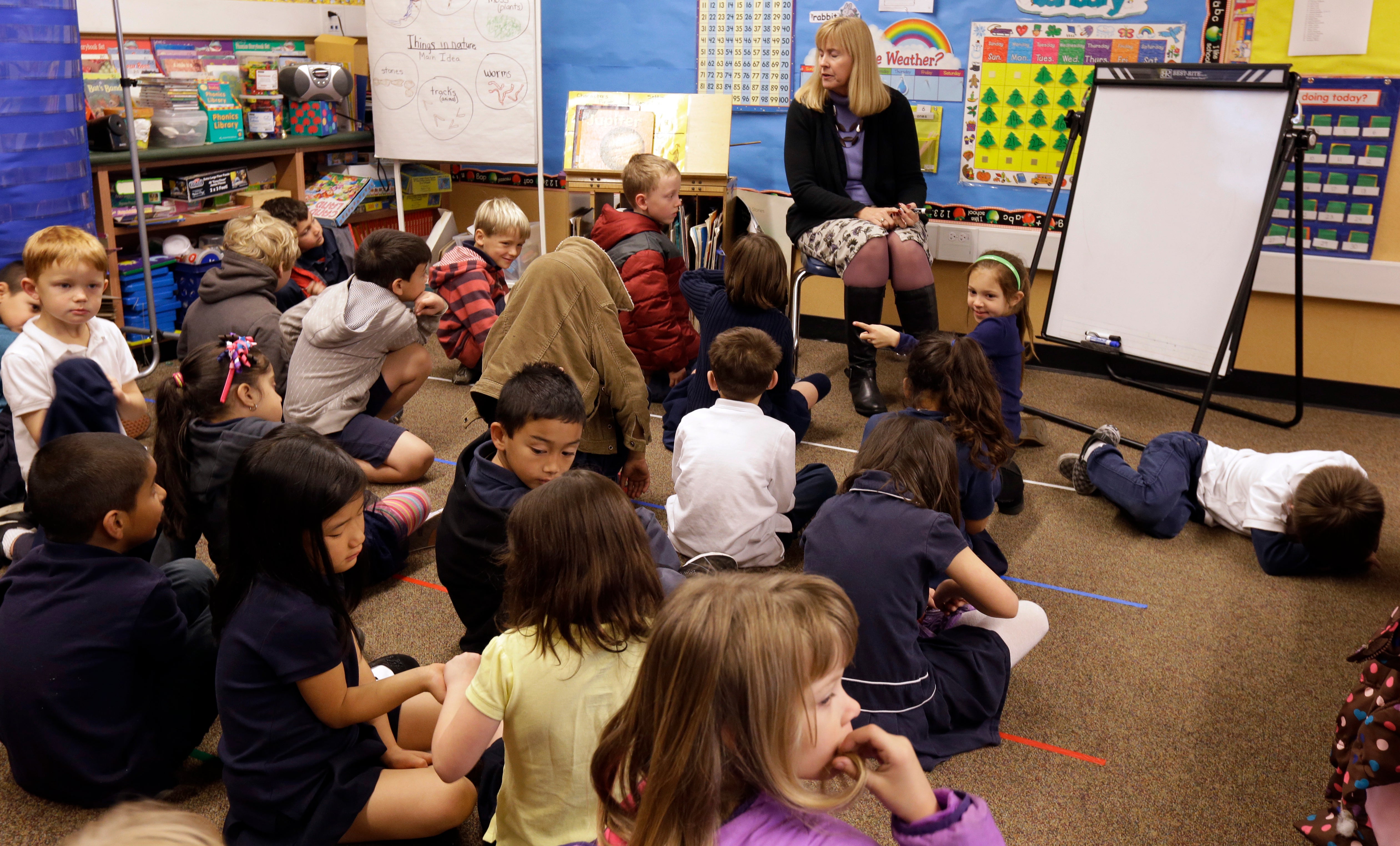 First grade teacher Lynda Jensen teaches her class of 30 children Thursday, Jan. 24, 2013, at the Willow Glenn Elementary School in San Jose, Calif. Classes in California's public schools are getting bigger. To save money on teacher salaries, school districts across the state have gotten into the habit of putting more children in classrooms and then seeking retroactive approval from the California State Board of Education.  Although bigger classes are unpopular with teachers and parents, research on the link between class size and learning has been inconclusive. (AP Photo/Ben Margot)