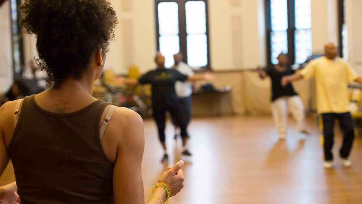 Older black volunteers do African dance together three times a week as part of a study. (Holli Stephens/for WHYY)
