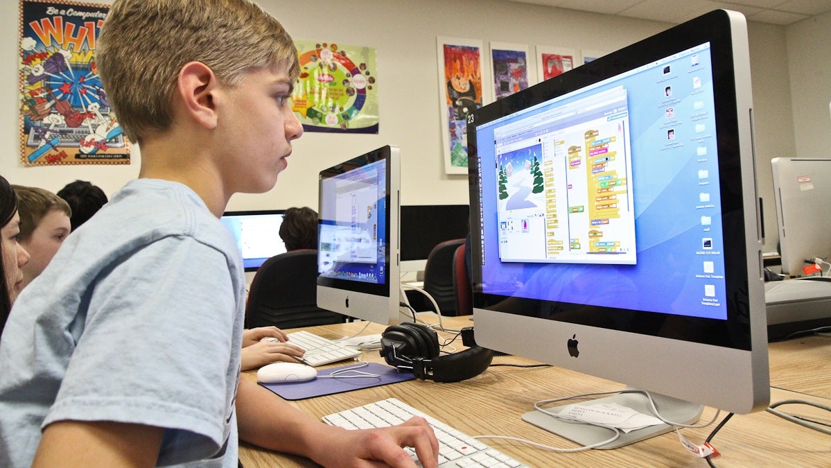 Moritz Endriss, 12, works on coding his holiday themed game at Penn Alexander elementary school. (Kimberly Paynter/WHYY)