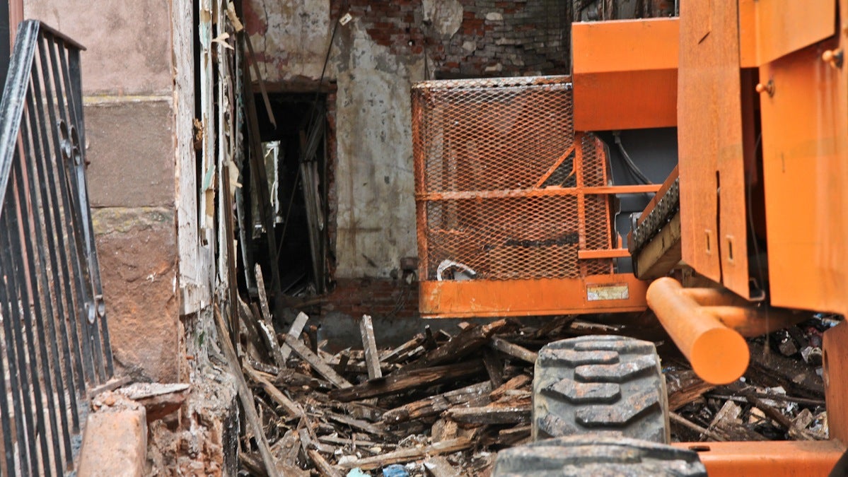  Two workers were injured Tuesday when they were hit with debris from an adjacent building during a scheduled city demo on the 3000 block of Diamond Street. (Kimberly Paynter/WHYY) 
