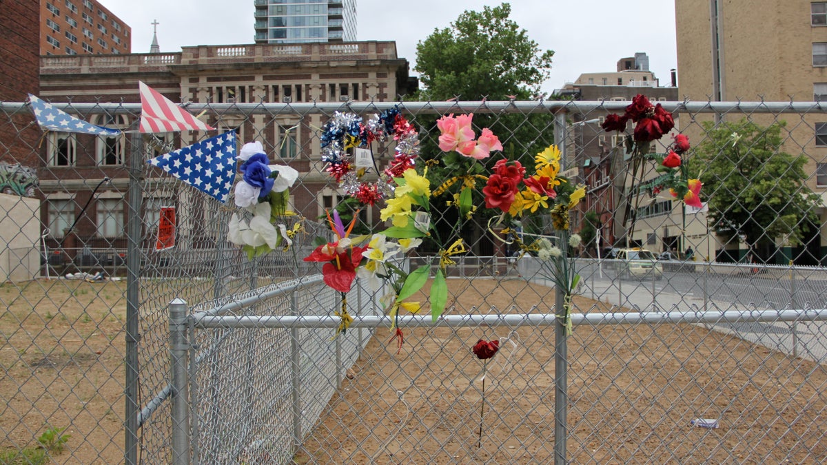  Chain link surrounds the site at 22nd and Market streets where the  Salvation Army Thrift Store collapsed a year ago, killing six. (Emma Lee/WHYY) 