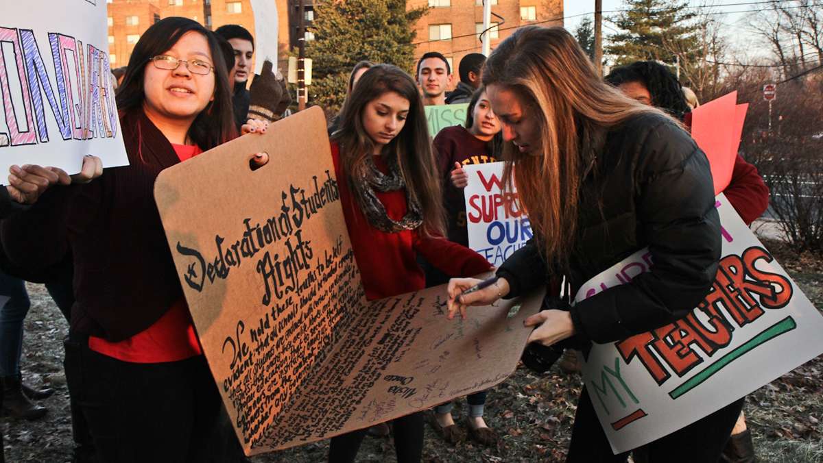  Central senior Dalya Hahan signs a Declaration of Student rights at a rally held outside the school prior to a visit from Pa Governor Corbett. (Kimberly Paynter/WHYY) 