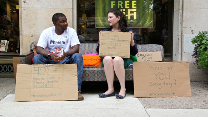  Shiykier Davis, who was homeless at 16 because of his sexual preference, shares a couch with Caitlin Pratt of Valley Youth House. The homeless support organization placed a couch in front of the Barnes & Noble at Rittenhouse Square to draw attention to the plight of LGBT youths who often find themselves 'couch surfing.' (Emma Lee/WHYY) 