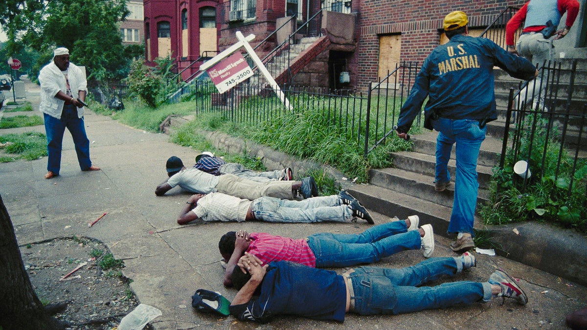  Attorney general Richard Thornburgh and Drug Czar William Bennett in Washington, July 17, 1989, released results of an eight week anti-drug initiative. Here, in photo taken during one of the raids, a U.S. Marshal, far left, keeps his pistol trained on suspects as other marshals raid a crackhouse. (AP Photo/Scott Applewhite) 