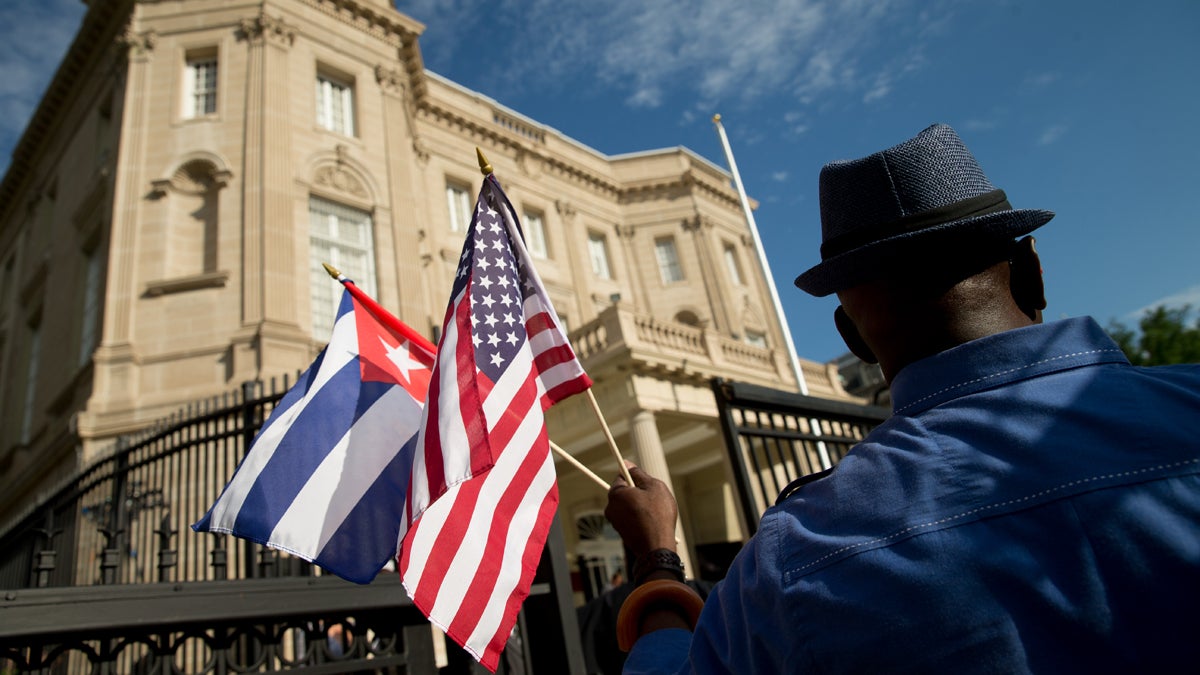  Edwardo Clark, a Cuban-American, holds an American flag and a Cuban flag as he celebrates outside the new Cuban embassy in Washington, Monday, July 20, 2015. The United States and Cuba restored full diplomatic relations Monday after more than five decades of frosty relations rooted in the Cold War. (AP Photo/Andrew Harnik) 